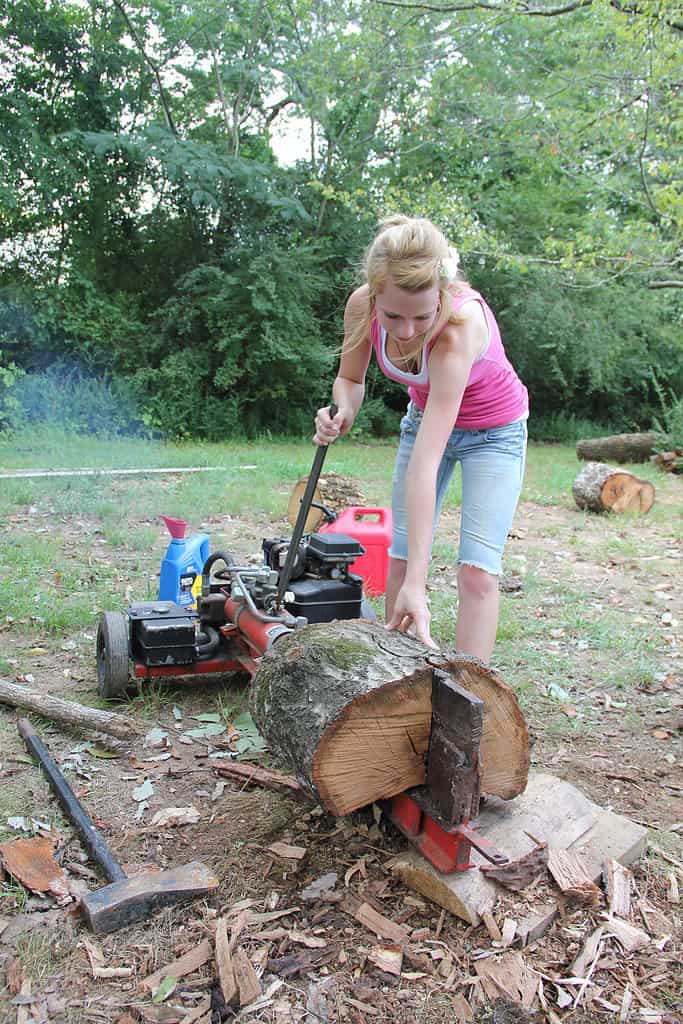woman using a log splitter