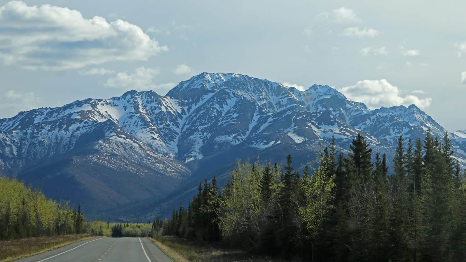 Alaska Highway near in the Tetlin National Wildlife Refuge with Nutzotin Mountains in the background in May