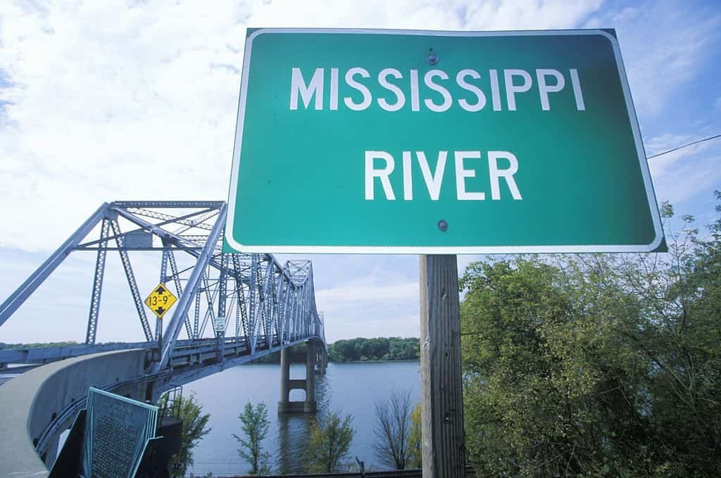Mississippi River sign in front of a truss bridge