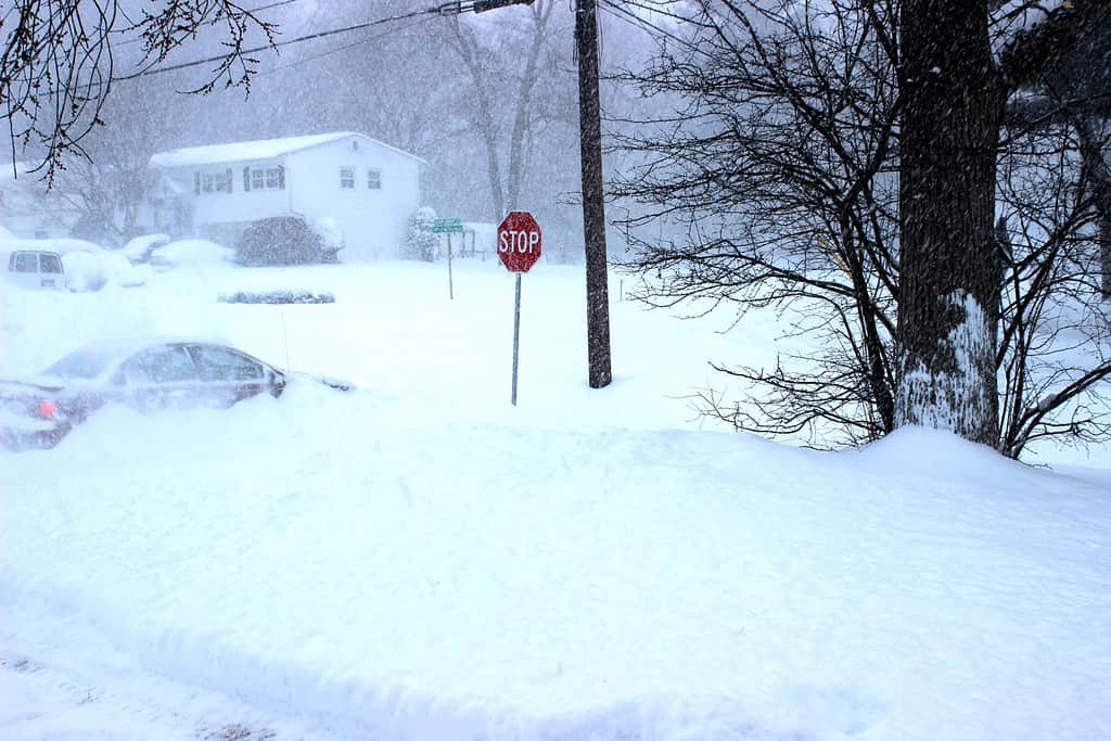 Red stop sign at the intersection says it all. End this winter nor'easter snowstorm insanity.
