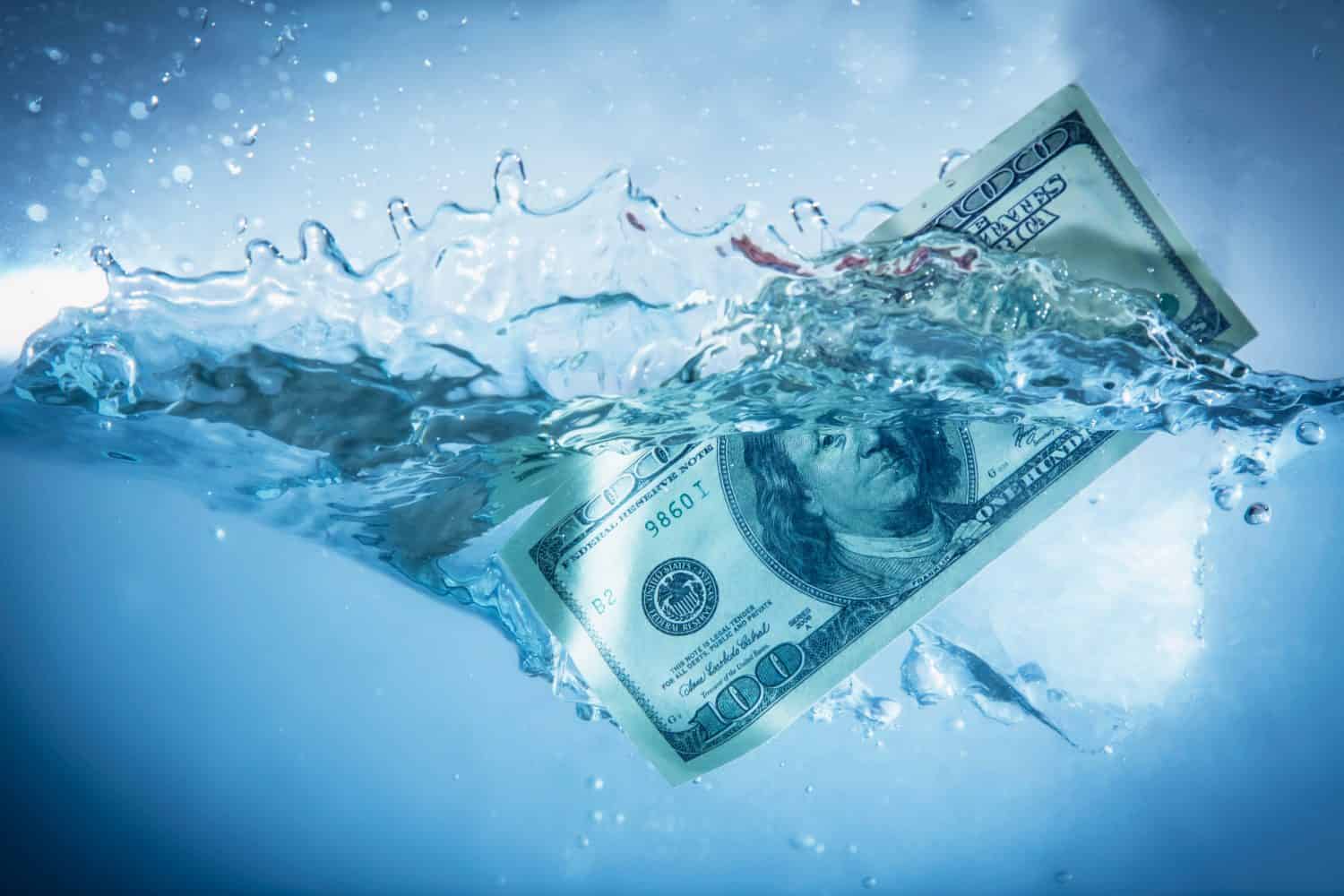 Global financiall crisis concept. US Dollar sinking in water