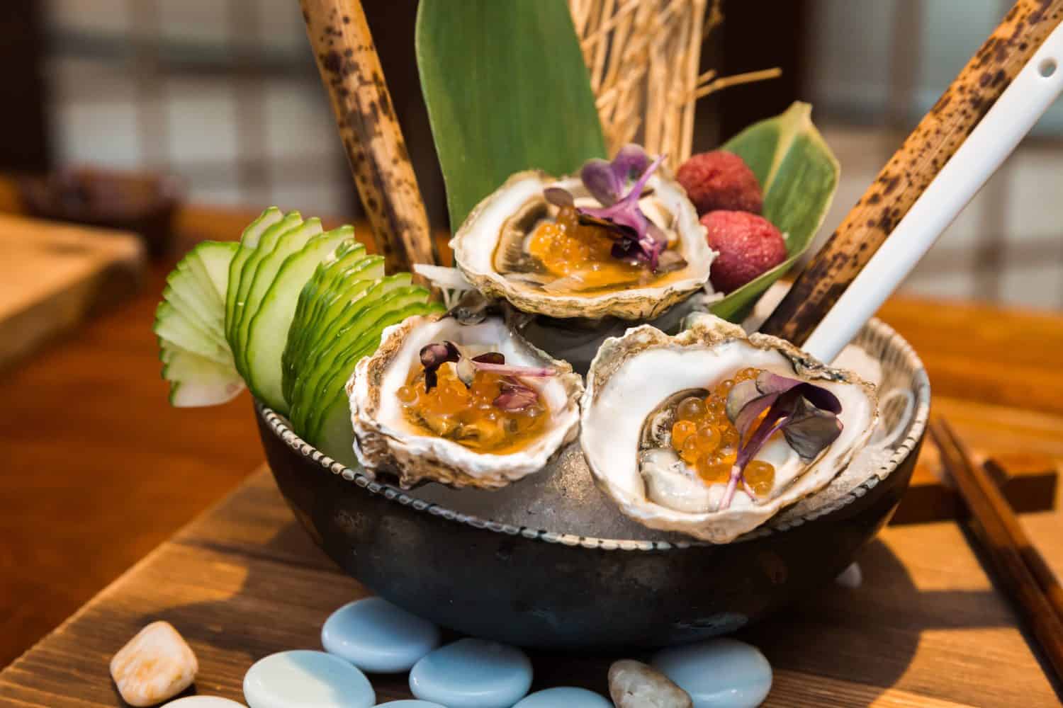 Japanese Kumamoto Oysters with salmon roe on a nice presentation