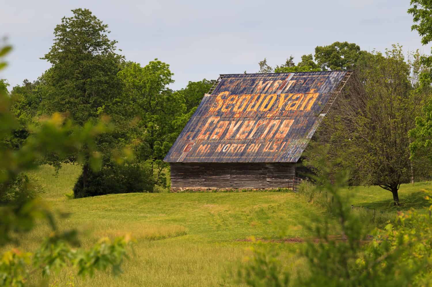 Old advertising barn with “Visit Sequoyah Caverns”  painted on the roof located in Valley Head, Alabama
