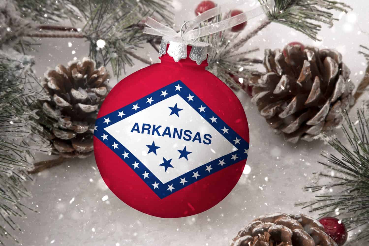 Christmas ball with the flag of Arkansas, decorates the snow tree with snowfall. The concept of the Christmas and New Year holiday