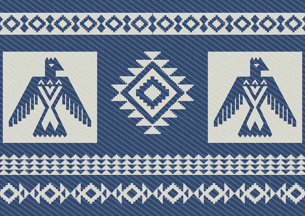 Abstract ethnic pattern with eagles. Blue denim background