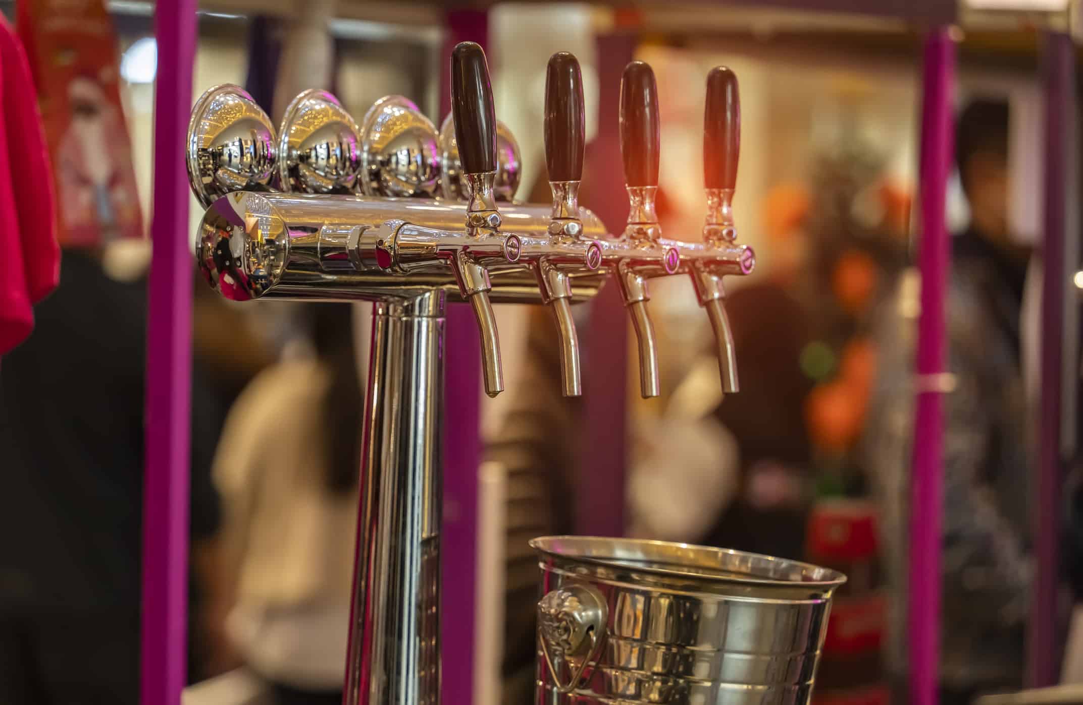 Draught beer taps in a bar.