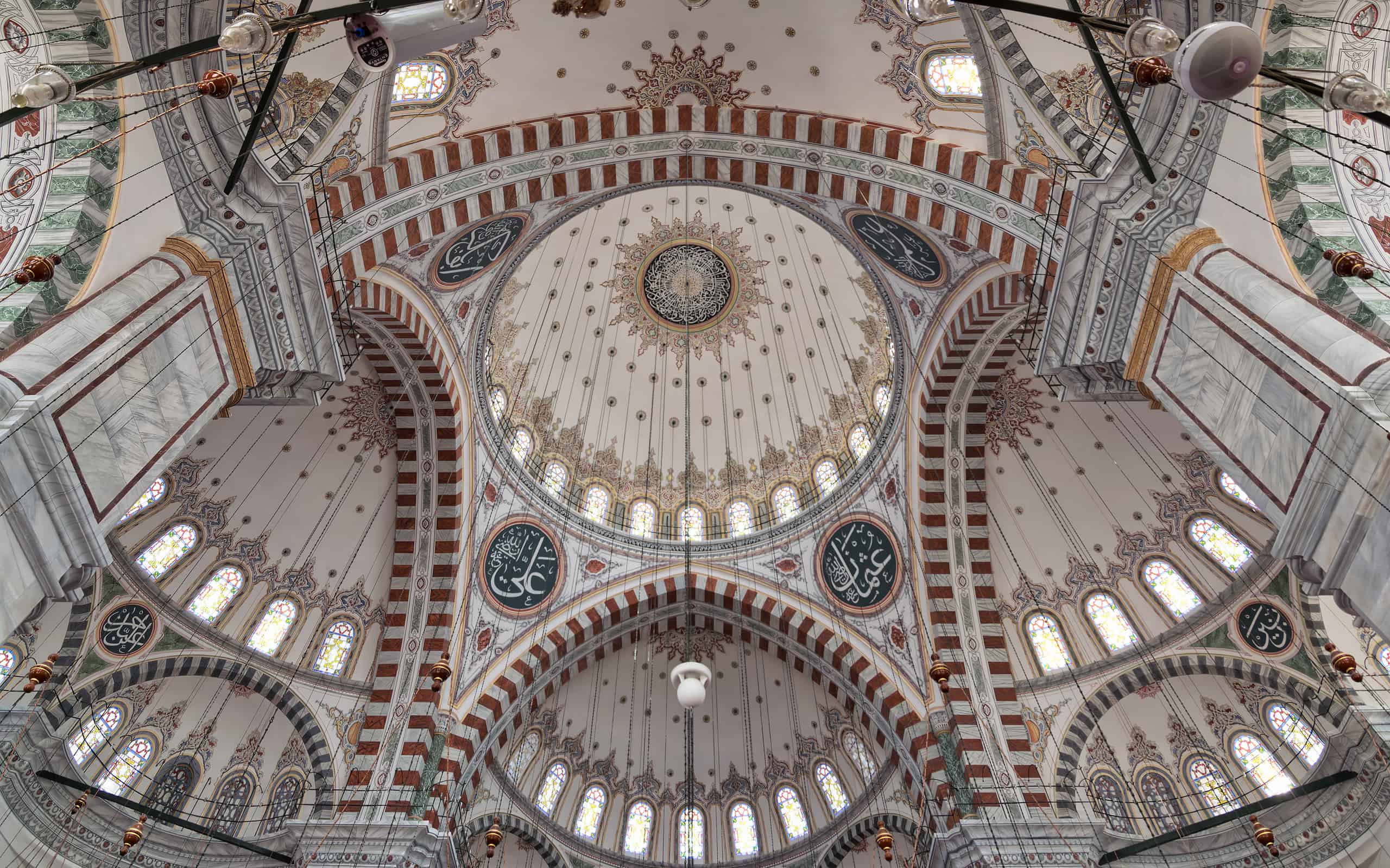 Ceiling of Ottoman Fatih Mosque in Istanbul, Turkey, made up of a series of decorated domes based on Islamic art