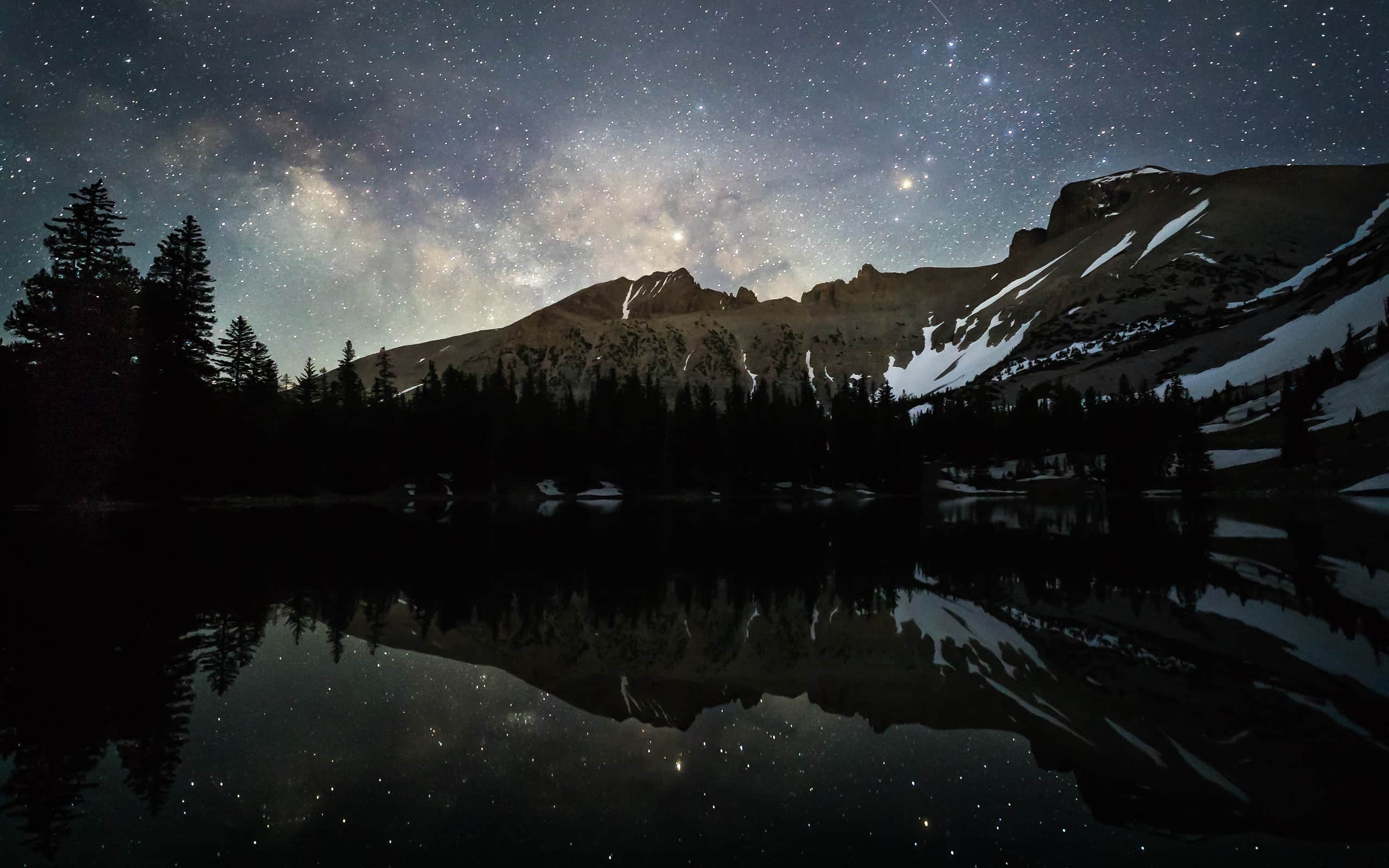 Milky Way reflected in mountain lake