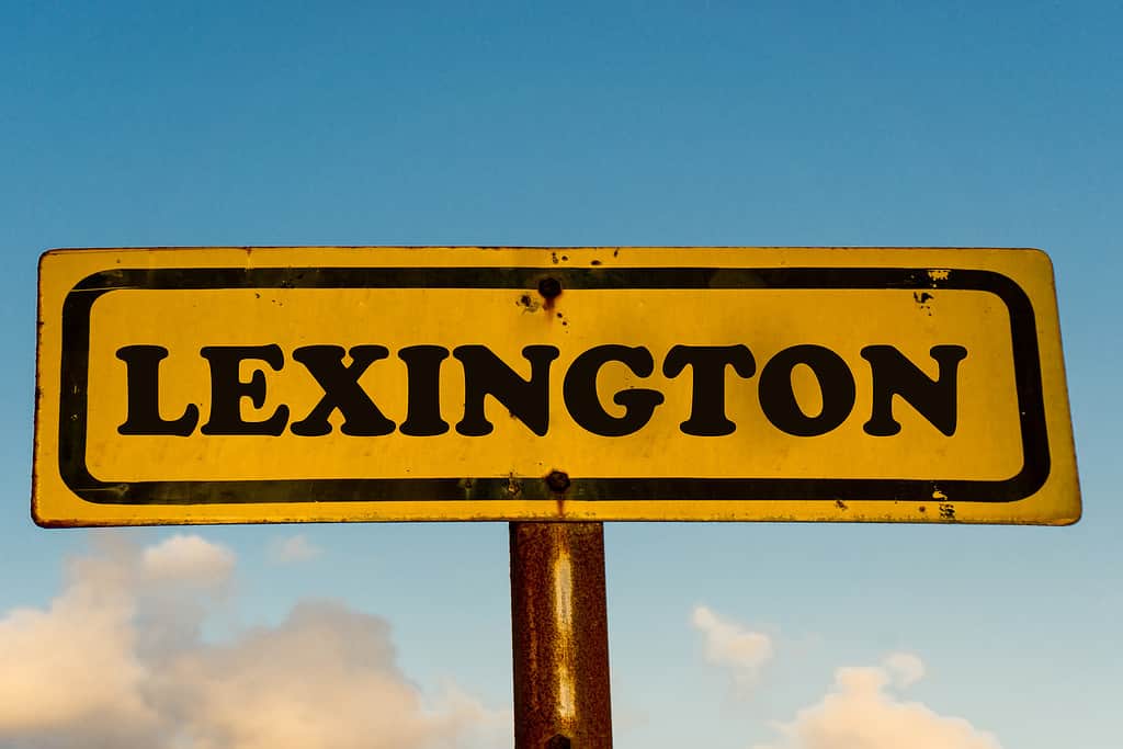 Lexington city street old antique yellow sign with blue sky at background, USA signal city series.