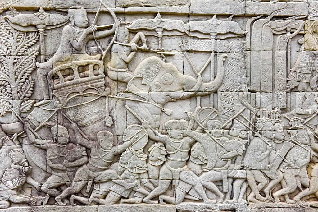 Bas relief sculpture, elephant charging into battle between the Cham and Khmer. Bayon Temple, Angkor Thom, Siem Reap, Cambodia
