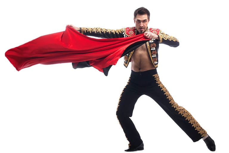 Handsome toreador in black costume with red cloth