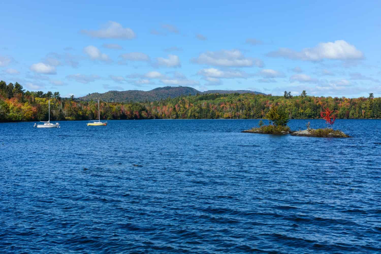 Boats on Umbagog Lake in New Hampshire with blue sky