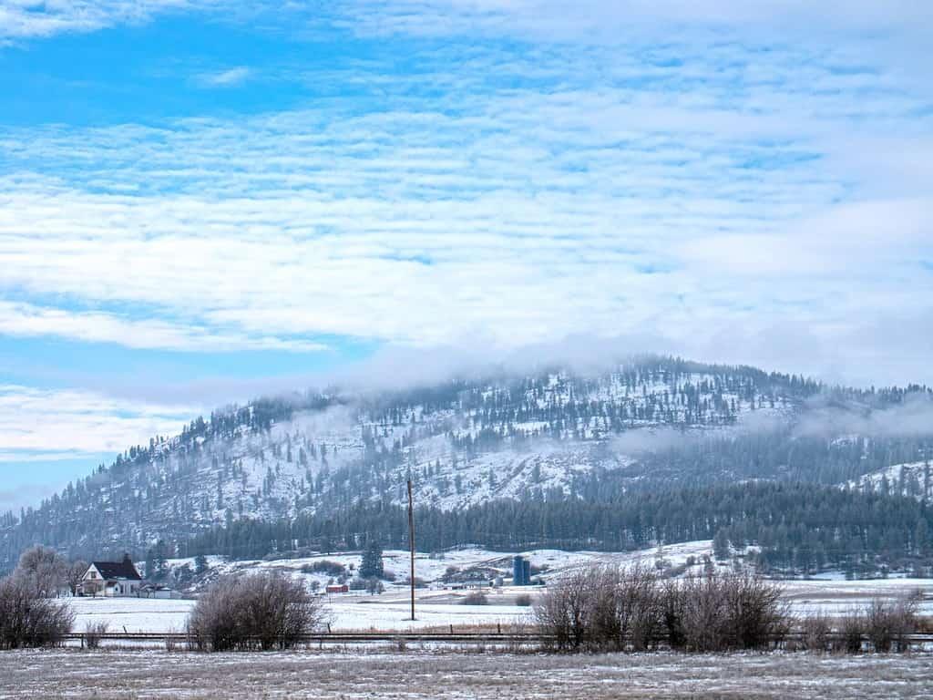 Chewelah Washington USA Farm Land Mountain Backdrop Snowy Winter Day Under Blue Sky Cloud Cover