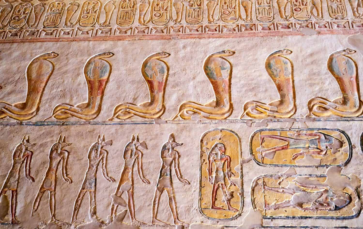                           Egyptian hieroglyphs of Wadjet, the protector cobra godess inside a tomb. Valley of the Kings, Egypt.   