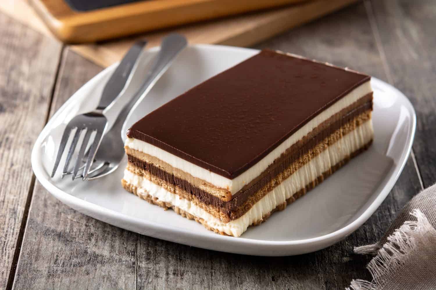 Opera cake dessert slice on wooden table