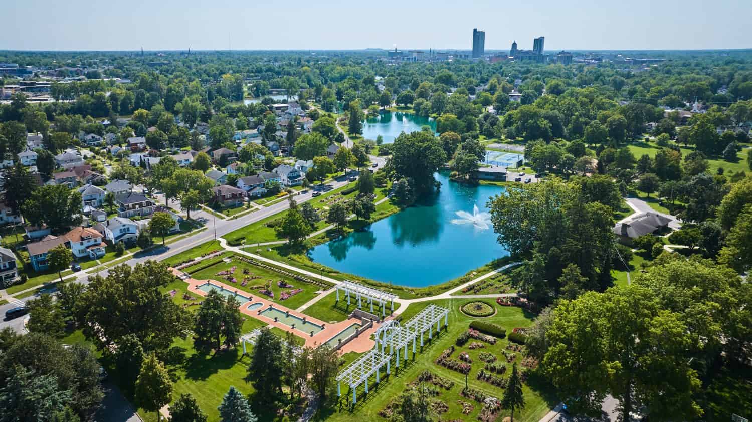 Aerial Lakeside Park gardens and fountains with distant downtown Fort Wayne