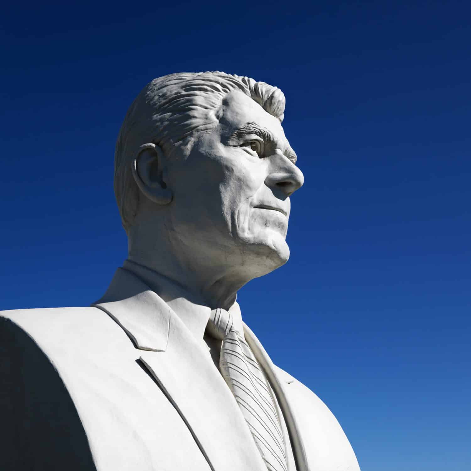 Bust of Ronald Reagan sculpture against blue sky in President's Park, Black Hills, South Dakota.