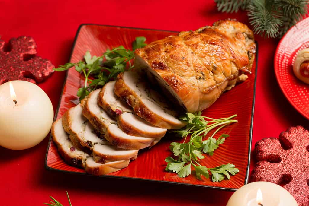 Christmas roll of turkey fillet stuffed with mushrooms and cheese