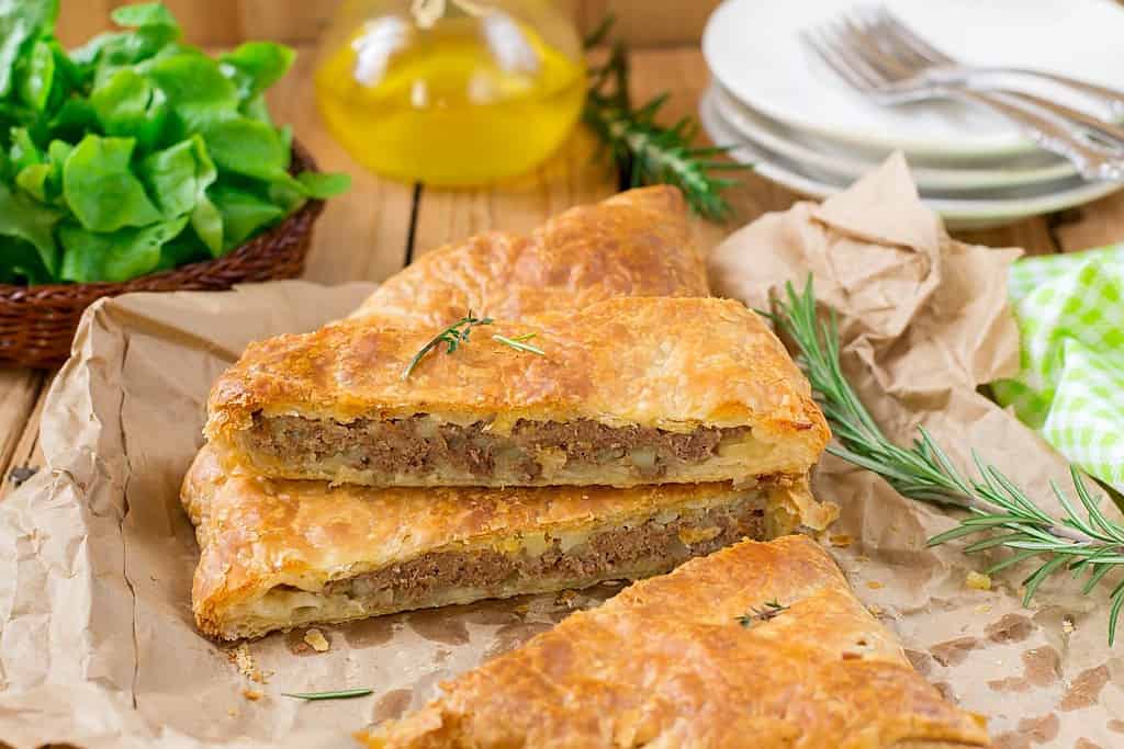 Meat pie with puff pastry, minced beef, onions and potatoes