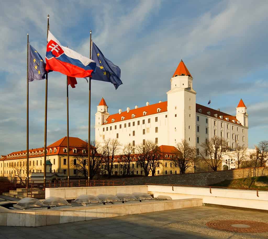 Bratislava castle with slovak flag and flag of European Union in the foreground