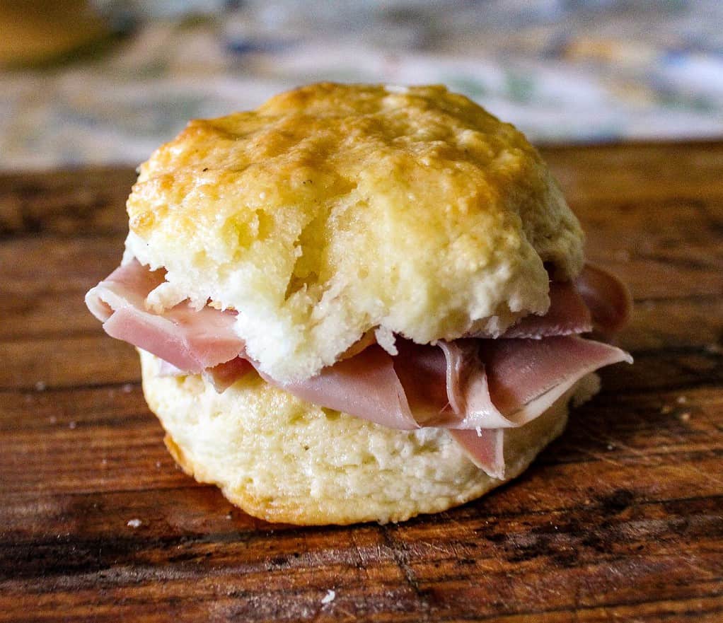 Soft Selective Focus of Buttermilk Biscuit with Country Ham on Wooden Cutting board