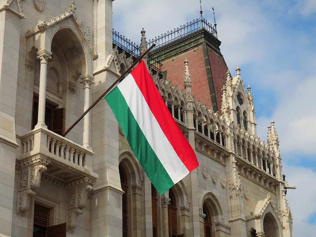 Hungarian tricolor national flag on the ornate building of the Hungarian Parliament in Budapest, Hungary