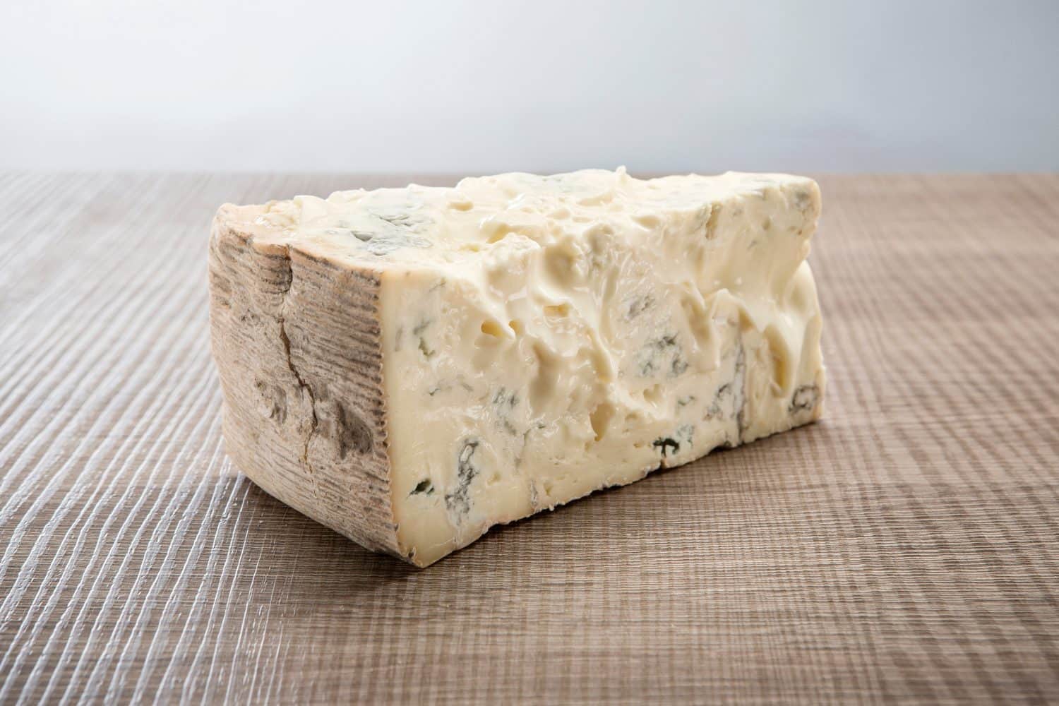 Gorgonzola Italian traditional aged blue cheese on wooden background