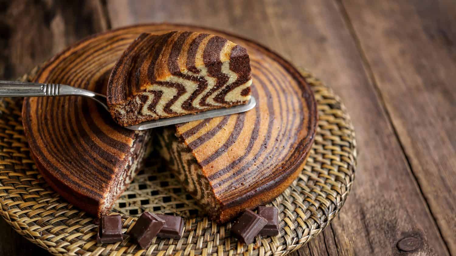 zebra cake with vanilla and chocolate on wooden table 