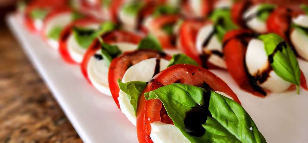Delicious caprese salad appetizer on a white serving plate