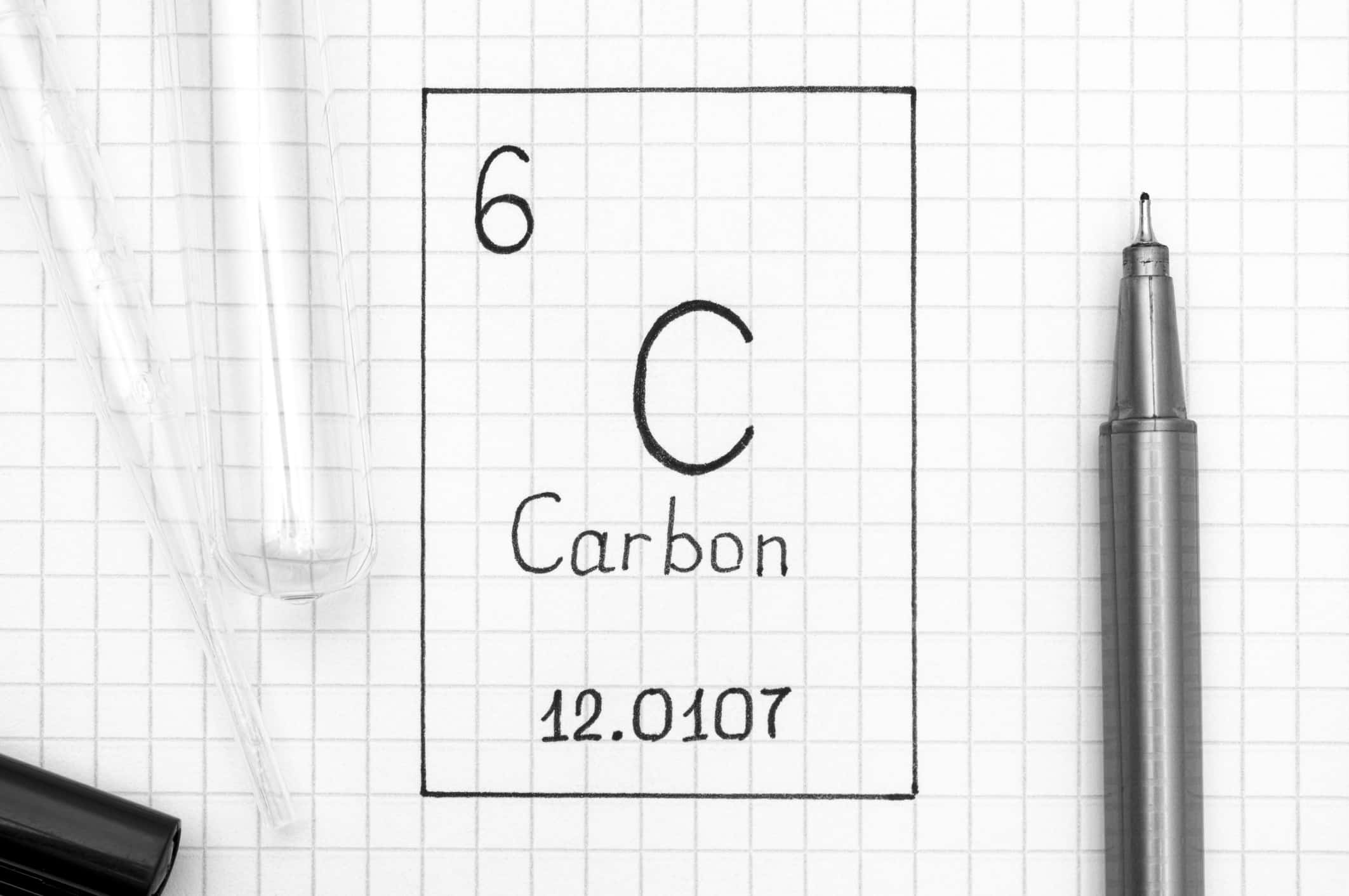Handwriting chemical element Carbon C with black pen, test tube and pipette.