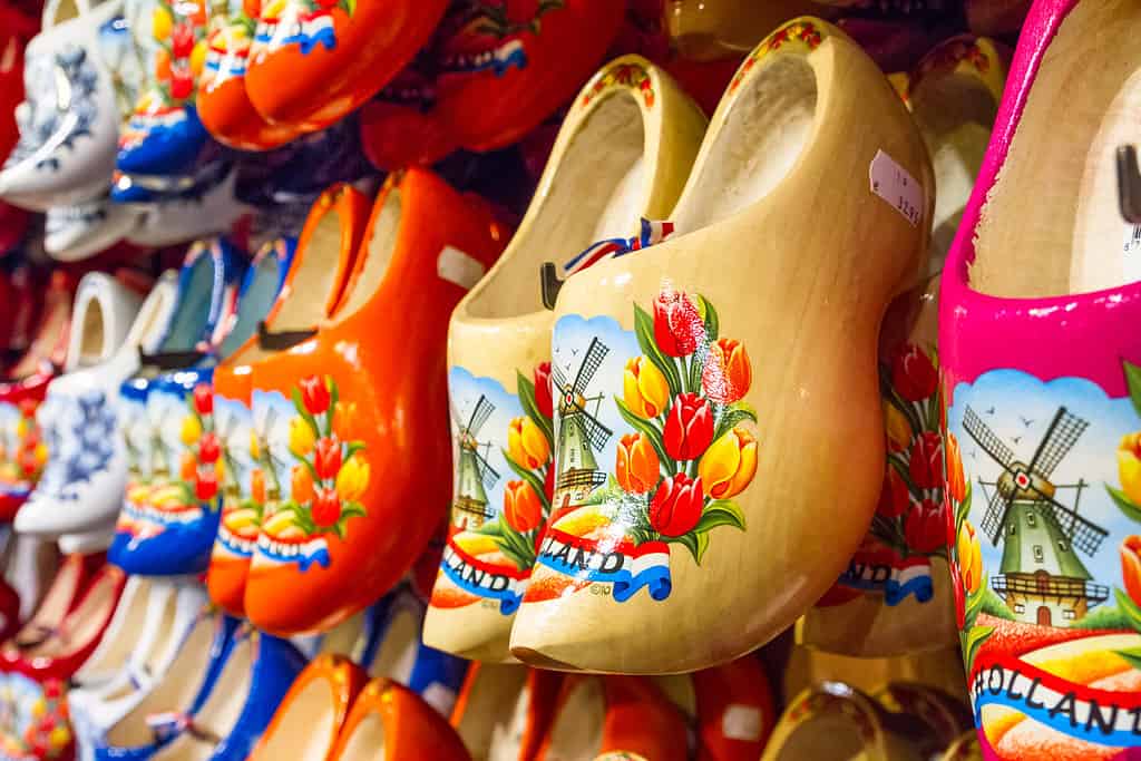 Rack in the store with rows traditional dutch wooden shoes - klompen (clogs)