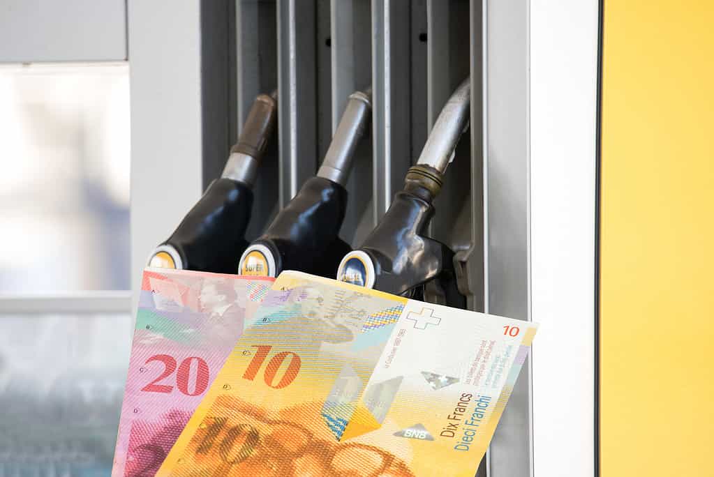 Petrol station in Switzerland and banknotes Swiss francs
