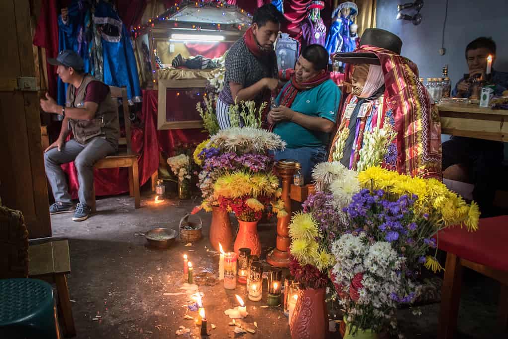 Mayan 'Saint' Maximón with offerings, guarded by a brotherhood in Santiago Atitlán, Guatemala