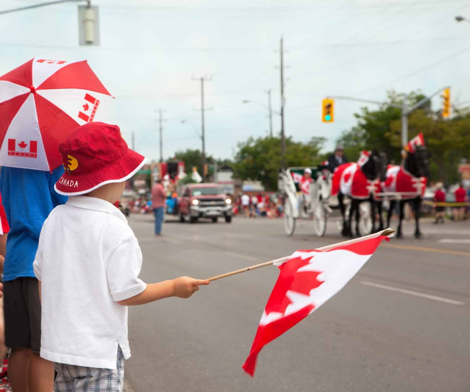 Boys watching a Canada Day parade. Aurora, Ontario, Canada.