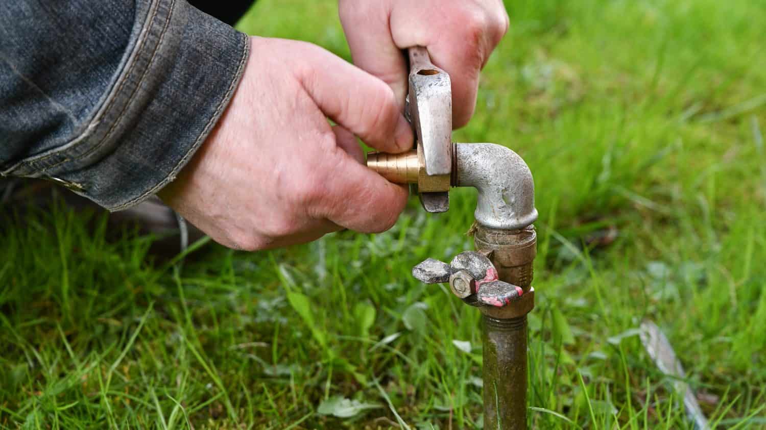 Man Fixing Garden Water Pipe. 