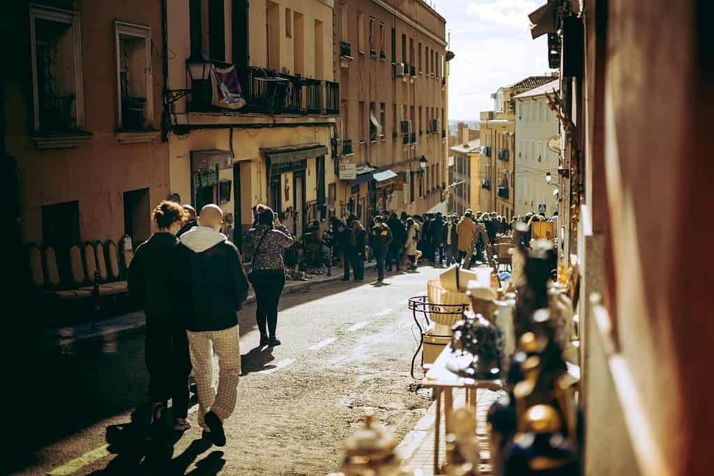 People walking walking down Madrid´` Rastro. Street market in madrid