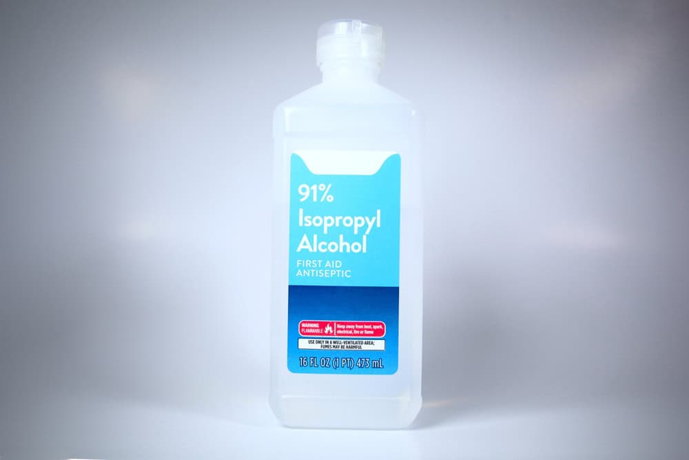 Isolated plastic bottle of 91% isopropyl alcohol with label