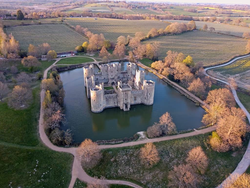 Aerial view of Bodiam Castle, 14th-century medieval fortress with moat and soaring towers in Robertsbridge, East Sussex, England.