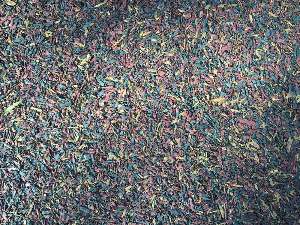 Colorful texture of a rubber floor on a playground. Soft mulch pattern background.