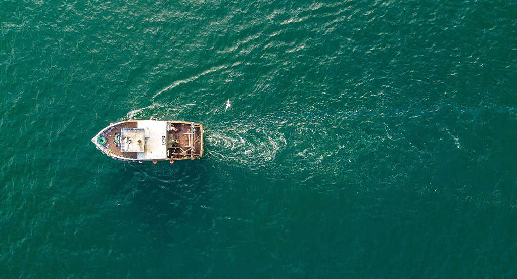 Small fishing trawler off a fishing coast