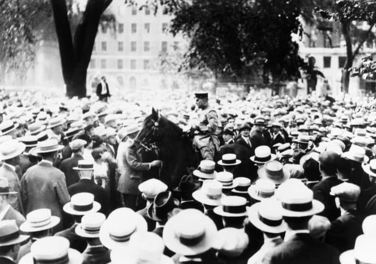 Policeman drives his horse through the crowds on Boston Common during a Sacco-Vanzetti protest. Speakers and Spectators were arrested. 1927.