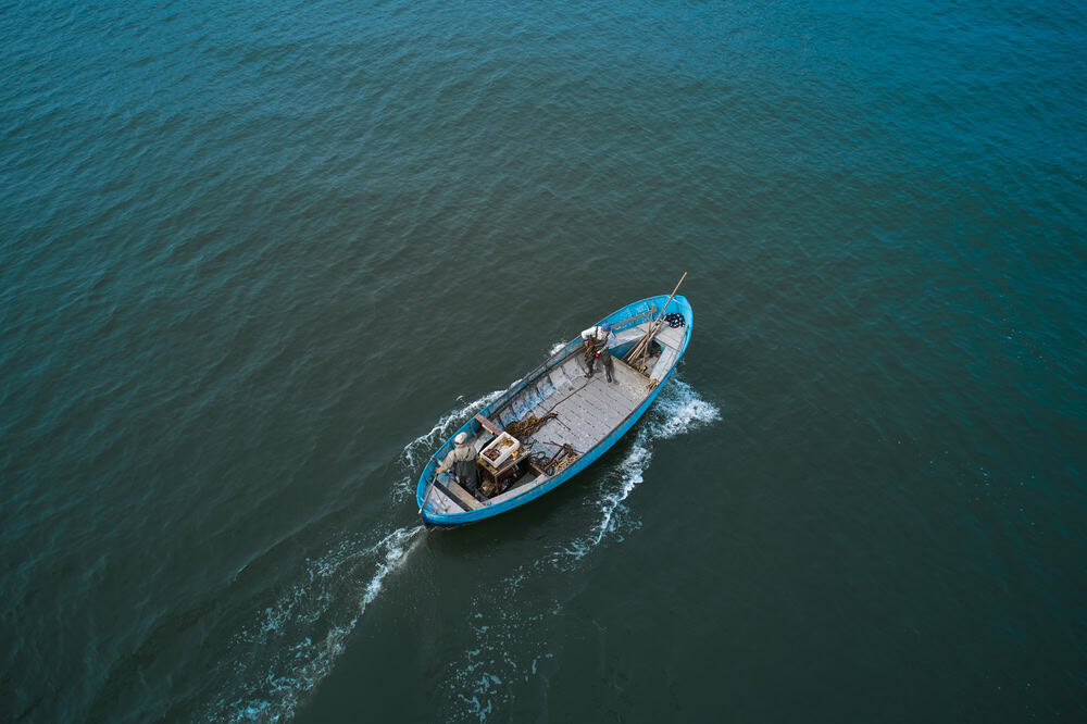 Fishing boats floating on the sea. Fishermans in boat. fishing boat sailing in open waters. man fishing on boat. sailing boat landscape