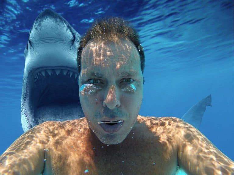 (photomanipulation)white man diving with shark. Scary selfie with shark under water. Shark behind his back with open jaw. most downloaded.