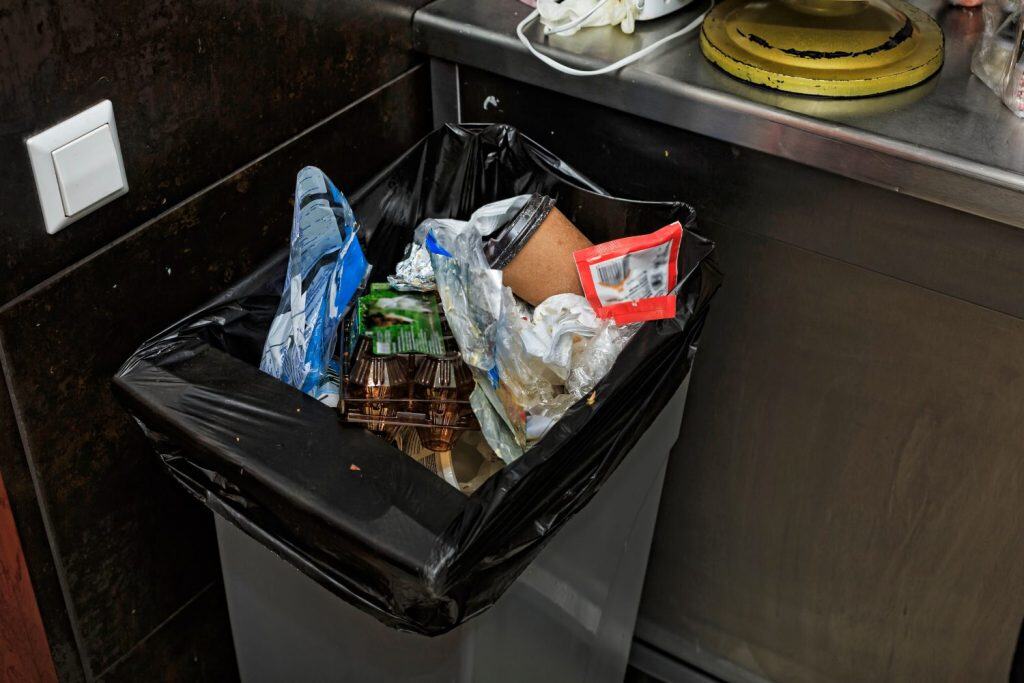 Garbage bin filled with garbage in the restaurant's kitchen