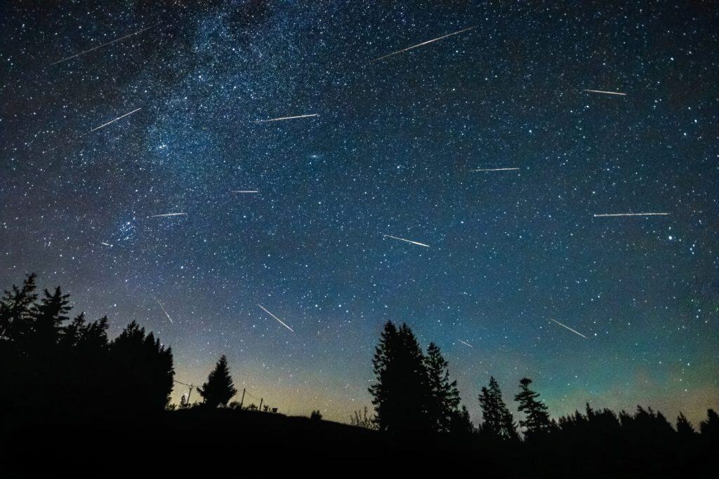 Perseid meteor shower in dark night sky with milky way. Dark sky area Beskydy in Czech Republic. Dark night summer sky with countless stars.