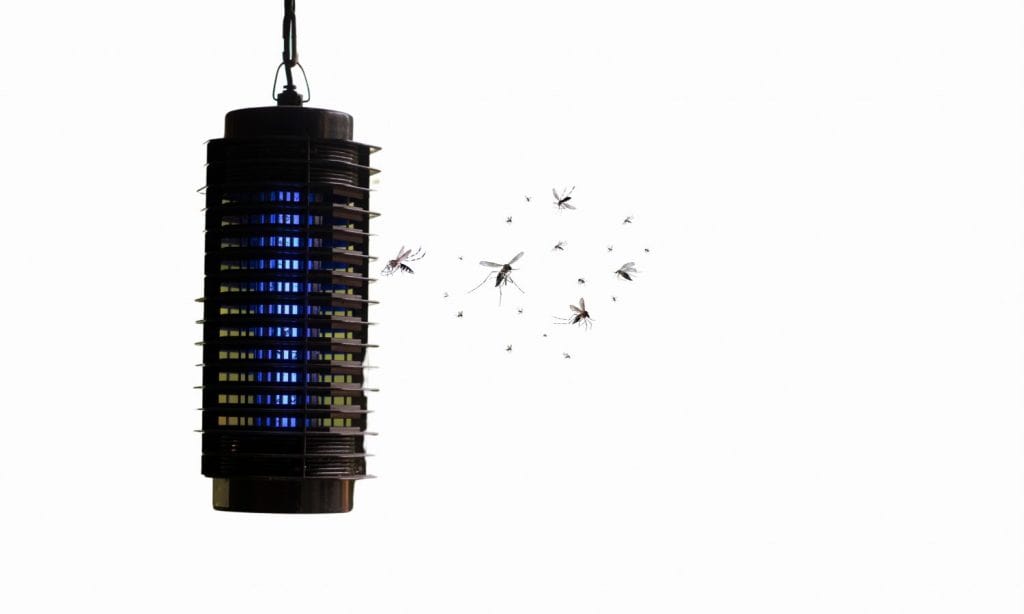Used electric mosquitoes and flies killer bug zapper racket handheld with hanging rope end hook, battery operated isolated on white background. Fly swatter pest control and insect catcher