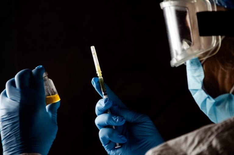 The Virology Center manufactures the vaccine. Doctor with Covid-19 vaccine. Mass vaccination concept.Testing the coronavirus vaccine. Close up of coronavirus vaccine.
