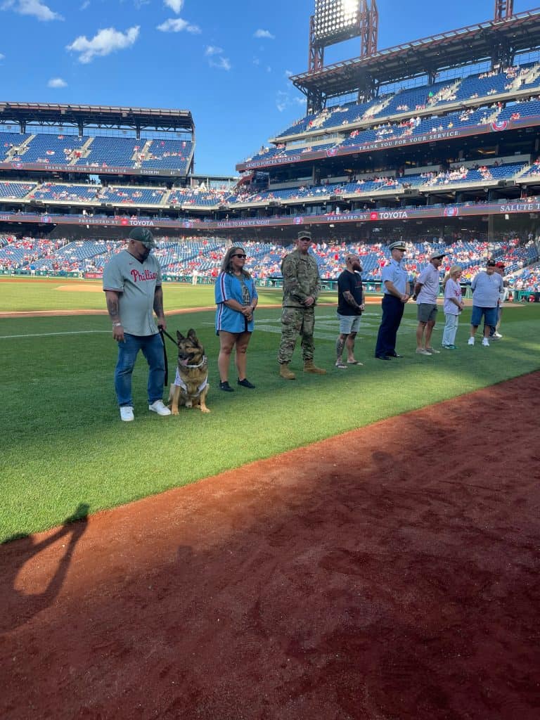 K9 Tambo and handler Chris Bingham being honored at Phillies game