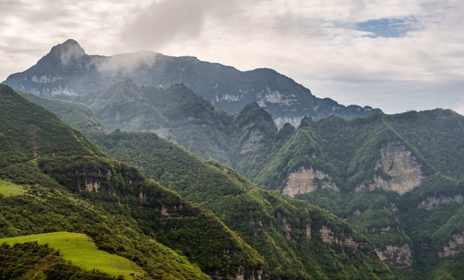 Looking at the steep cliffs of the Hengduan Mountains near Dawa Mountain in Leshan Sichuan Province from afar