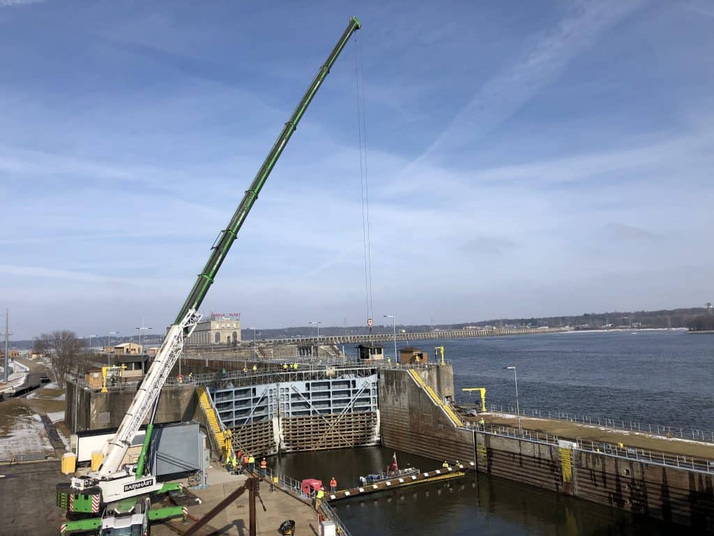 crane on left next to a canal with lots of construction works alongside a river